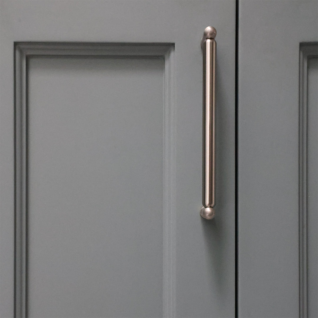 Gray cabinet door with a bronze handle