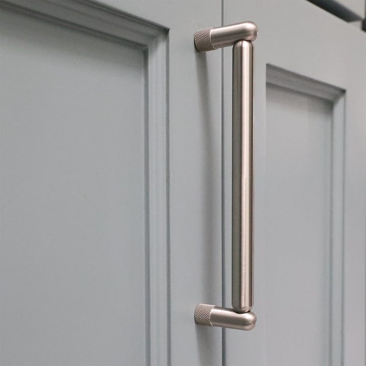 Metal handle on a gray cabinet door
