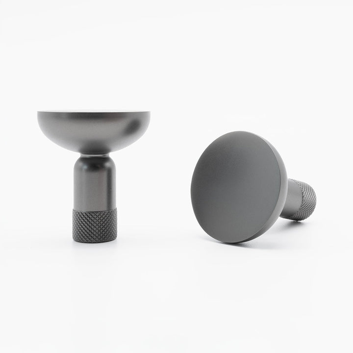 Two Hapny Knurled cabinet knobs in a graphite finish, one standing and one angled lying down.