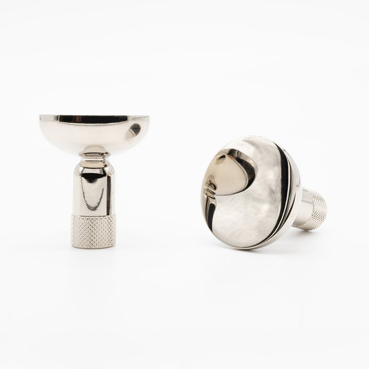 Two Hapny Knurled cabinet knobs in a polished nickel finish, one standing and one angled lying down.