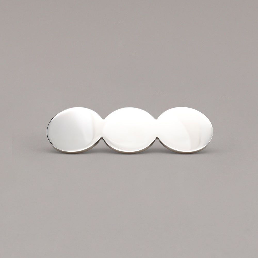 Statement polished nickel circular cabinet pull on a gray background
