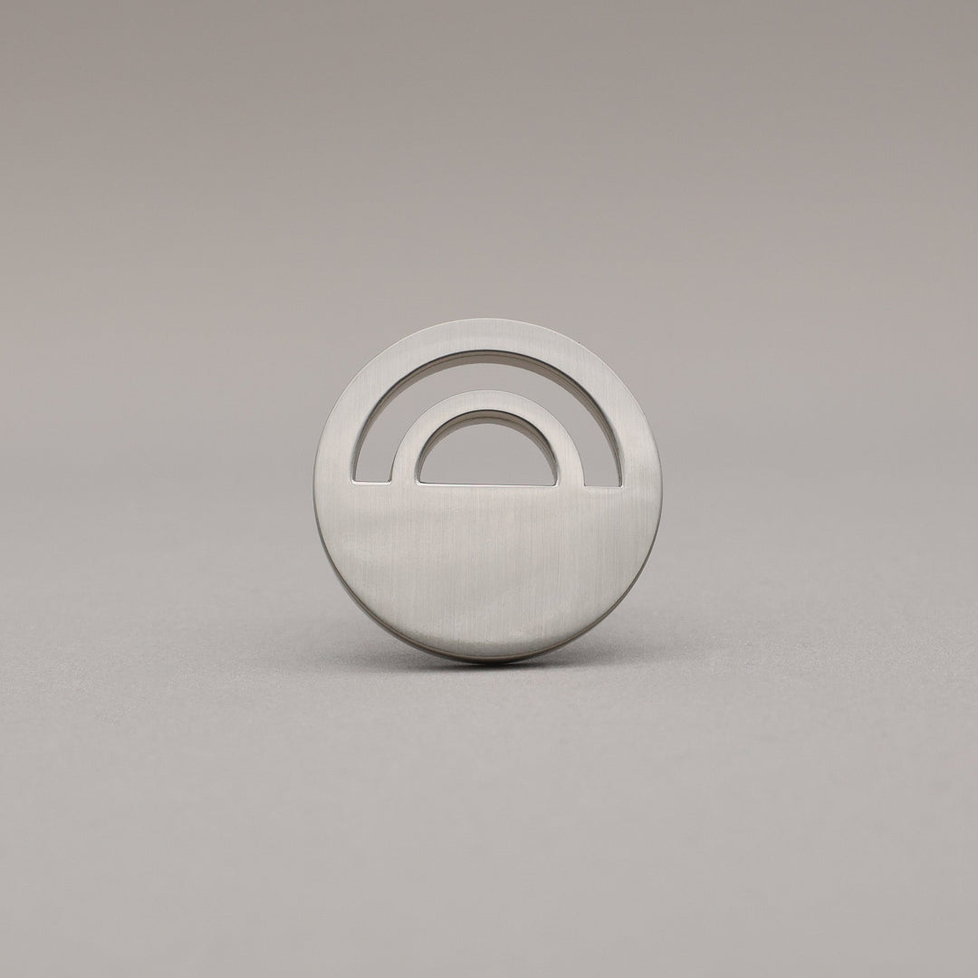 Horizon Satin Nickel Knobs on grey background.