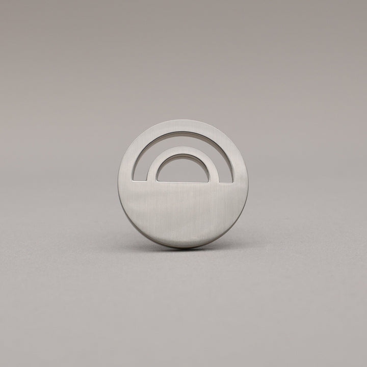 Horizon Satin Nickel Knobs on grey background.