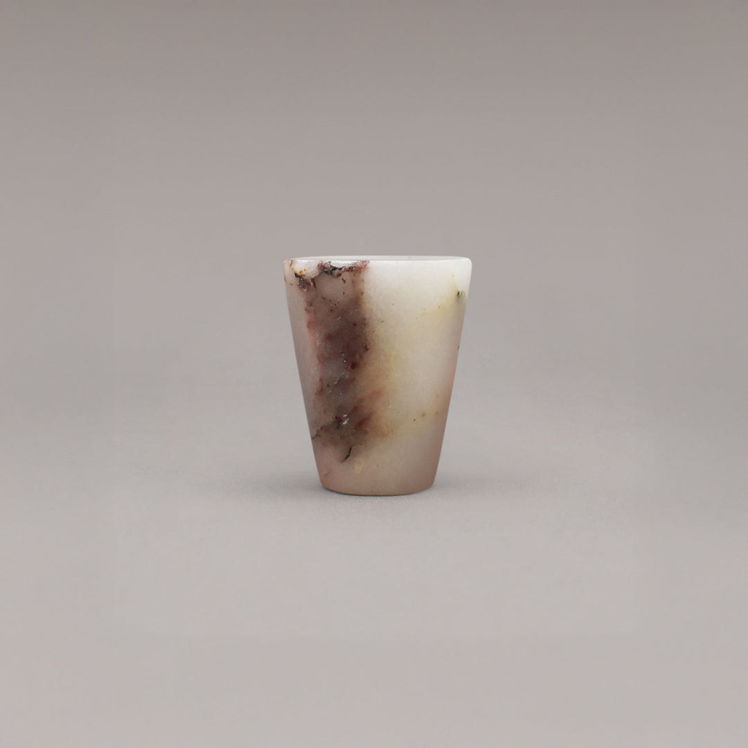 Marbled stone knob on a gray background